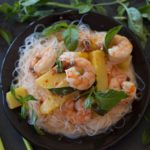 pineapple shrimp curry surrounded by Thai basil