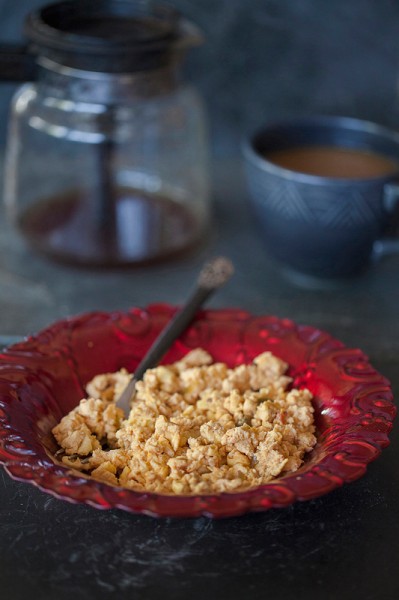 scrambled-eggs-and-gorgonzola on a red glass plate with a pot of coffee recipe photo
