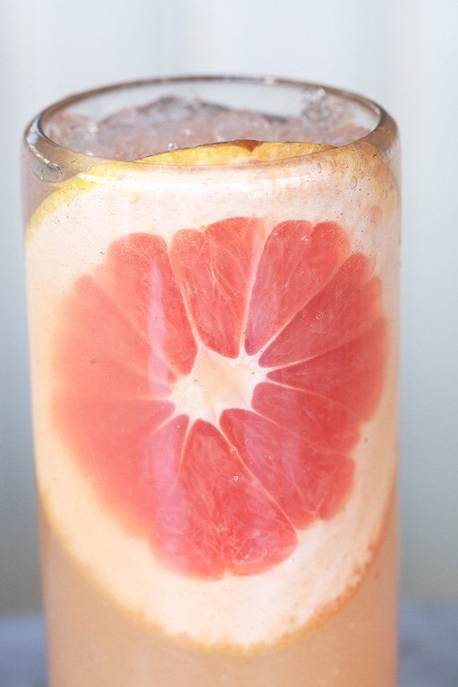 Paloma tequila cocktail with a slice of grapefruit in the glass
