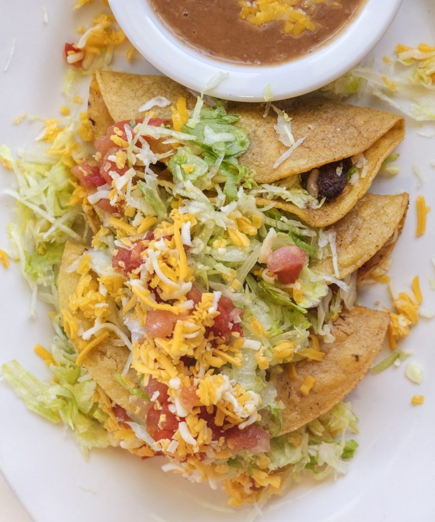 Ground beef patties folded into handmade tortillas and then friend before loading with the traditional toppings. One of our iconic Tucson dishes. Food photography and article by Jackie Alpers.