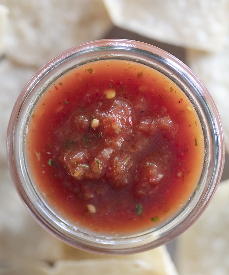 red chiltepin hot salsa surrounded by tortilla chips