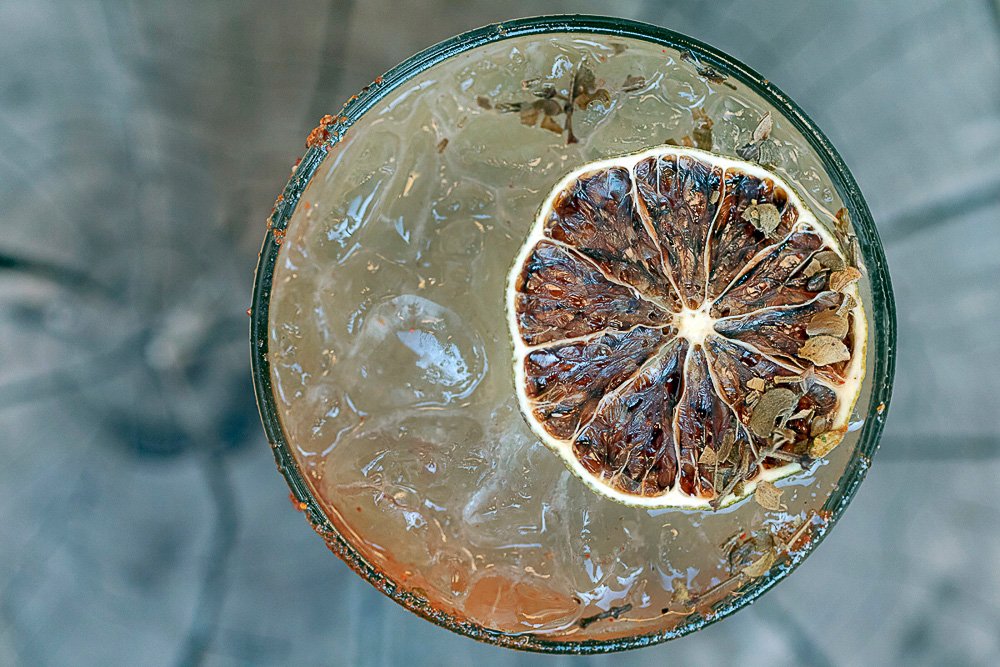 dried lime and creosote floating in a chile rimmed margarita