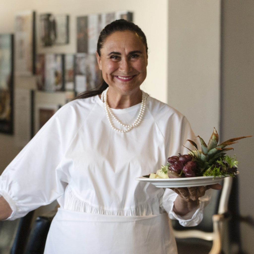 portrait of Poca Cosa chef Suzana Davila holding a pretty salad