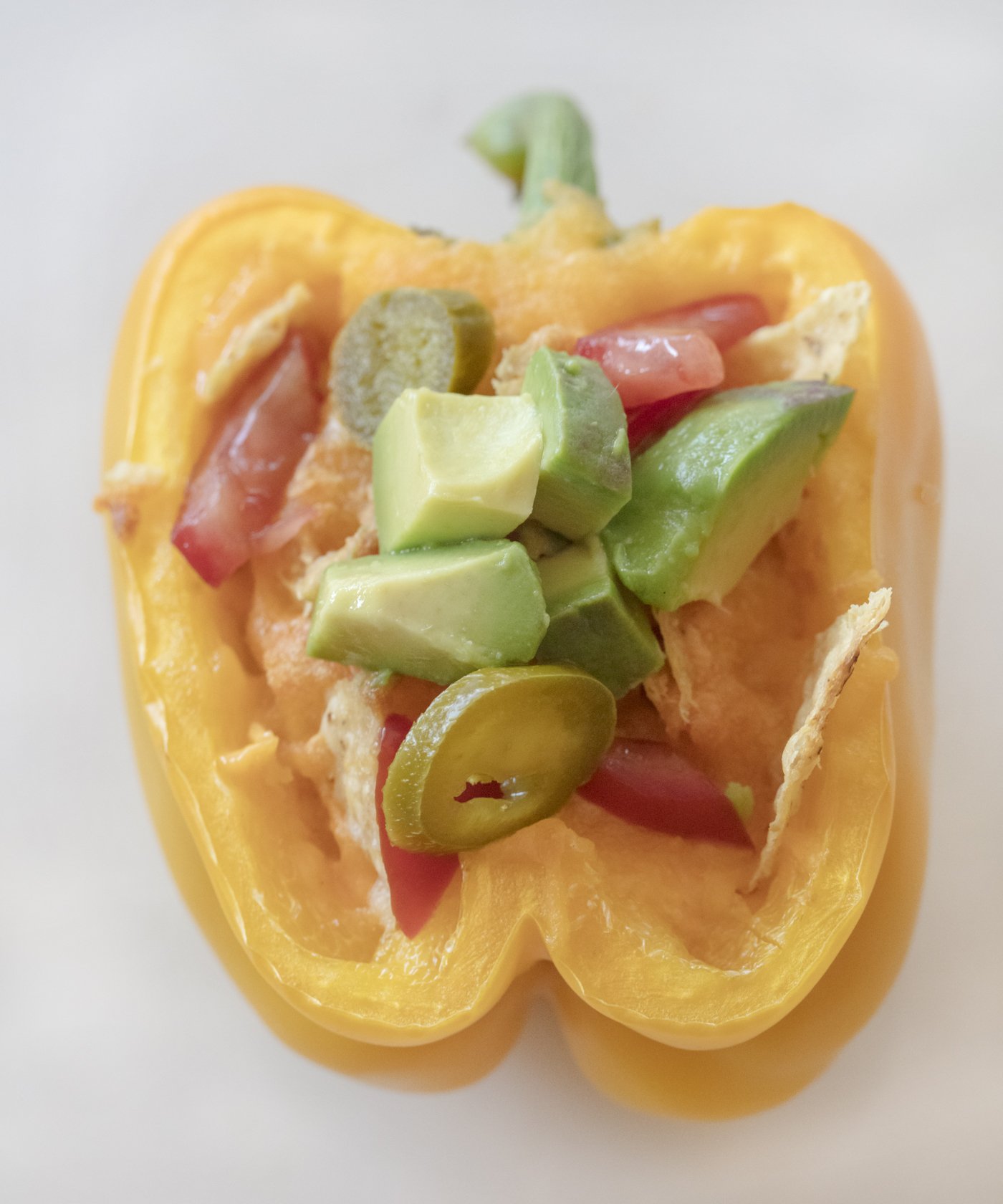 yellow bell pepper stuffed with nacho cheese, avocado jalapeños and tortilla chips