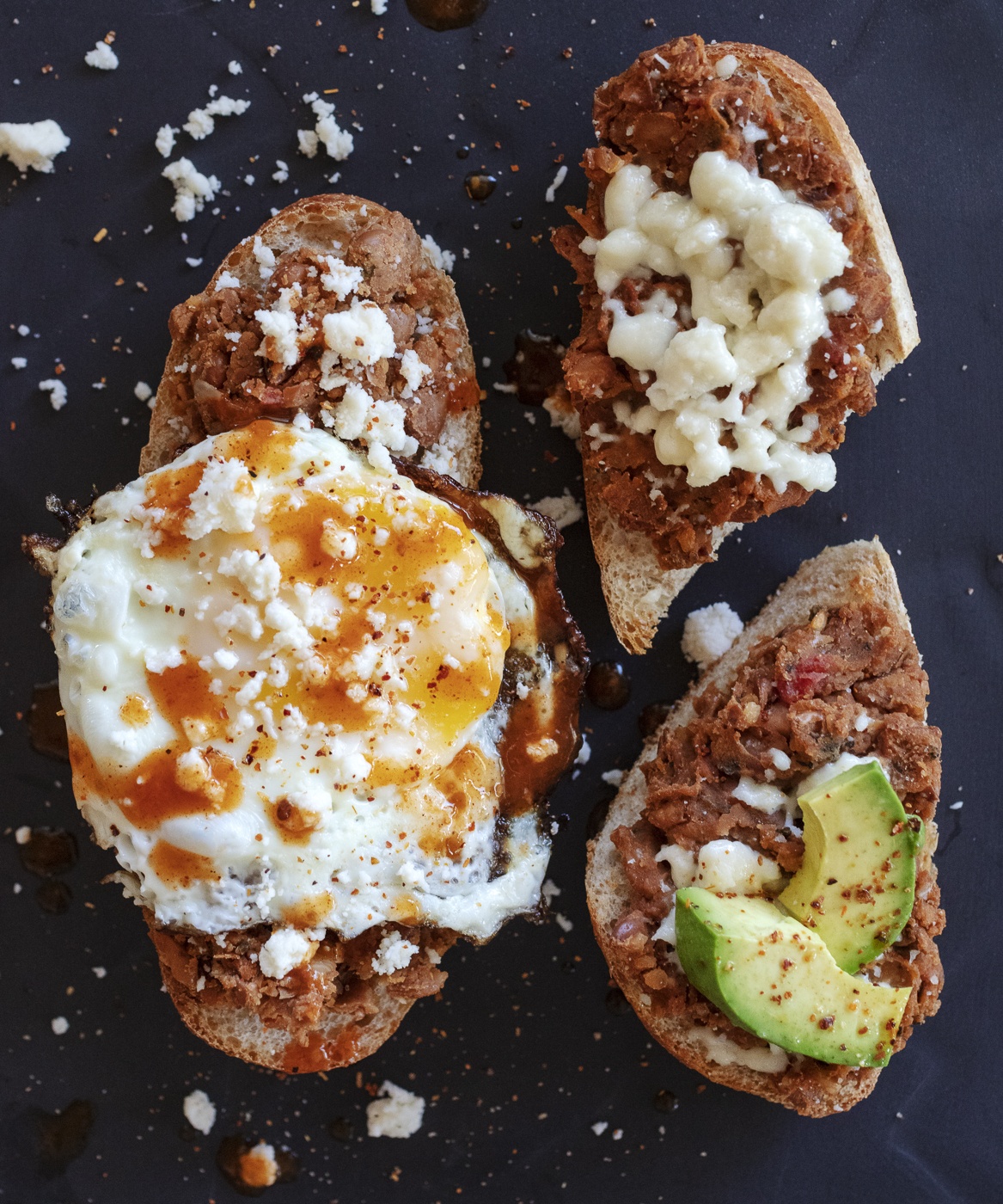 molletes with egg, queso fresco, beans avocado and hot sauce