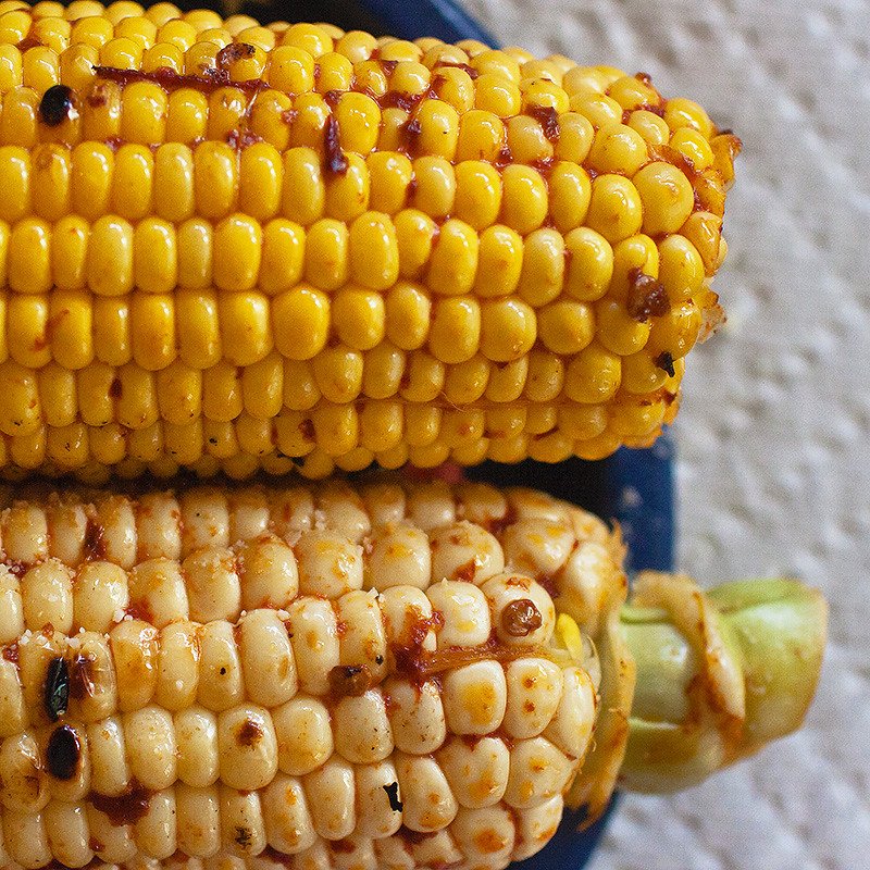 Ears of yellow corn with chipotle and cheese