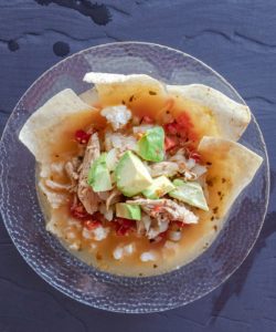 Chicken tortilla soup with avocado and corn tortilla chips