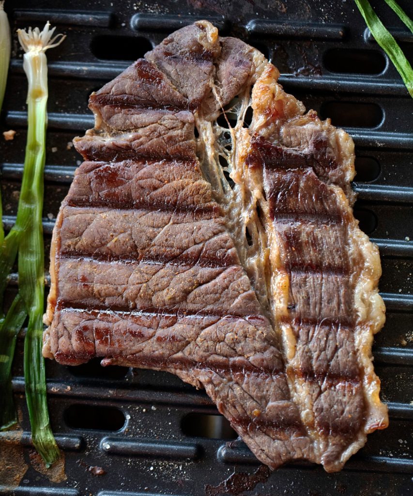 carne asada steak and green onions on a George Foreman grill