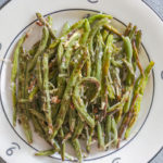 Pan roasted green beans with garlic and butter on a 6666 Ranch plate from Yellowstone cookbook author Jackie Alpers