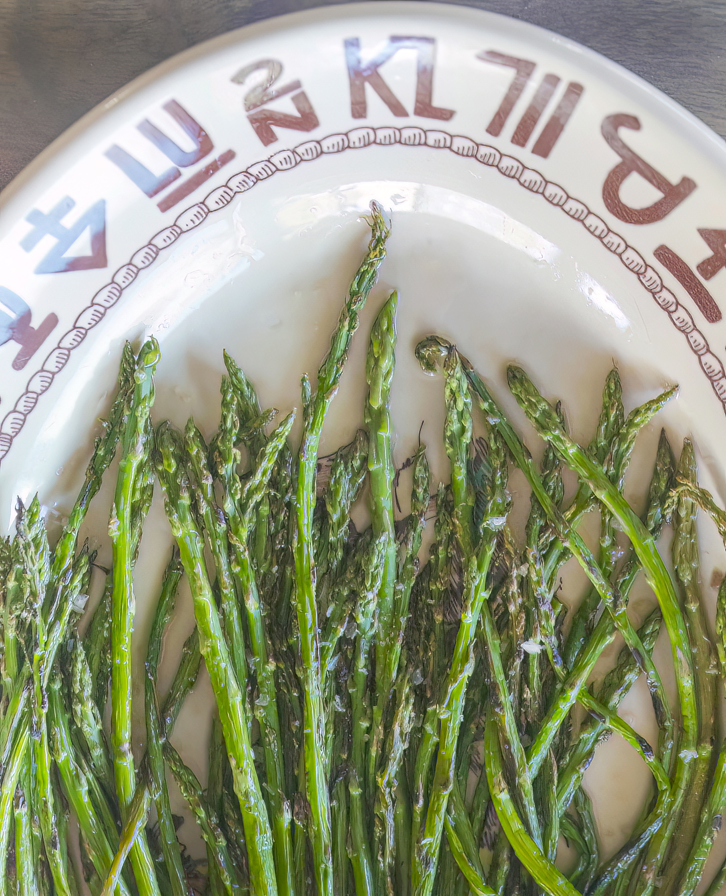 Dry-fried asparagus is charred and crispy on the outside, and tender on the inside. Photography and recipe by Jackie Alpers using Westward Ho plates from the Yellowstone TV series