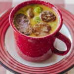 Yellowstone Inspired rattlesnake sausage chowder served in a red Le Creuset mug.