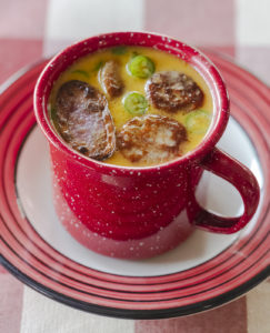 Yellowstone Inspired rattlesnake sausage chowder served in a red Le Creuset mug.