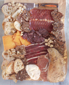 wild game charcuterie board with truffle butter from The Unofficial Yellowstone Cookbook by Jackie Alpers