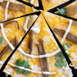 slices of flour tortilla cheese crisp with mexican blend cheese roasted green chile strip, cilantro leaves and ranch spiral.