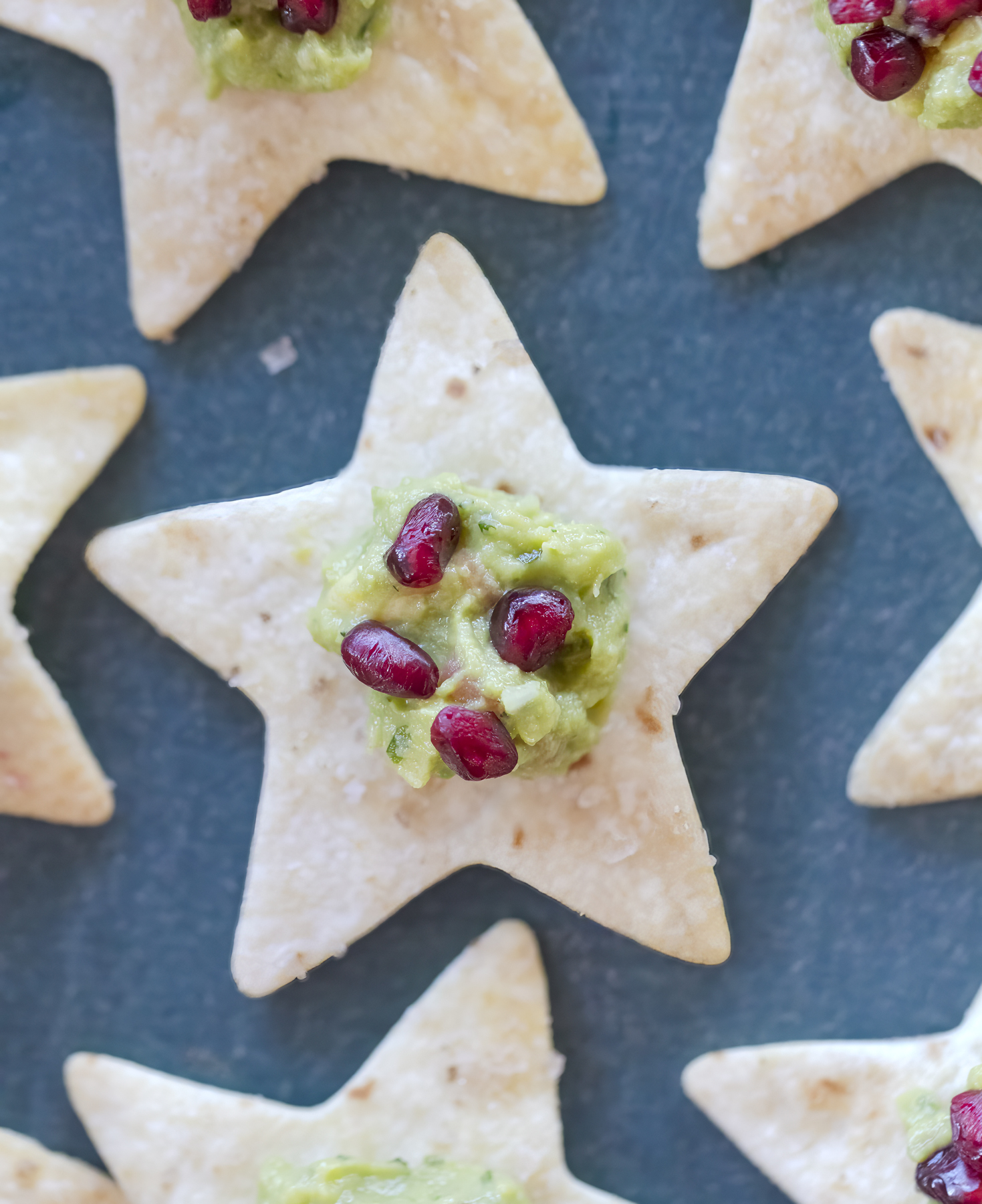 recipe and food photography by Jackie Alpers of tortilla stars with guacamole and pomegranate seeds for The Unofficial Elf Cookbook.