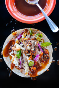 Peking-inspired Sonoran-style roast goose tacos with shredded cabbage, carrots, Salsa Macha and hoisin sauce. Food photography and recipe by Jackie Alpers.