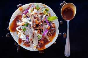 Peking-inspired Sonoran-style roast goose tacos with shredded cabbage, carrots, Salsa Macha and hoisin sauce. Food photography and recipe by Jackie Alpers.