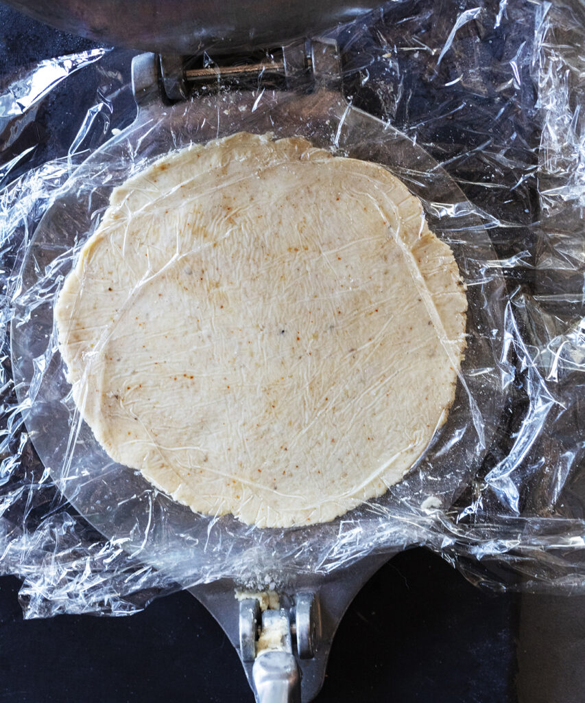 How to make blue corn tortillas step 5 flatten: recipe and food photography by Sonoran cookbook author Jackie Alpers.recipe by Jackie Alpers for the Taste of Tucson cookbook.