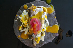 Recipe for Sonoran Sardine Tacos on homemade blue corn tortillas, golden salsita, pickled onion and cabbage. Recipe and food photography by Taste of Tucson cookbook author Jackie Alpers.
