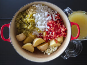 Sonoran style Caldo de queso soup with large chunks of potatoes, melty cheese, mexican oregano and chiltepin. Food photography and recipe by Jackie Alpers author of the Taste of Tucson cookbook.