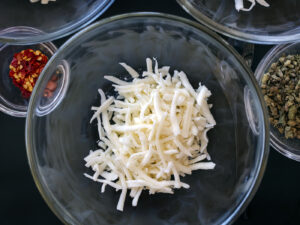 Caldo de queso soup prep with large chunks of potatoes, melty cheese, mexican oregano and chiltepin. Food photography and recipe by Jackie Alpers for Serious Eats.