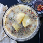 Caldo de queso soup with large chunks of potatoes, melty cheese, mexican oregano and chiltepin. Food photography and recipe by Jackie Alpers for Serious Eats.